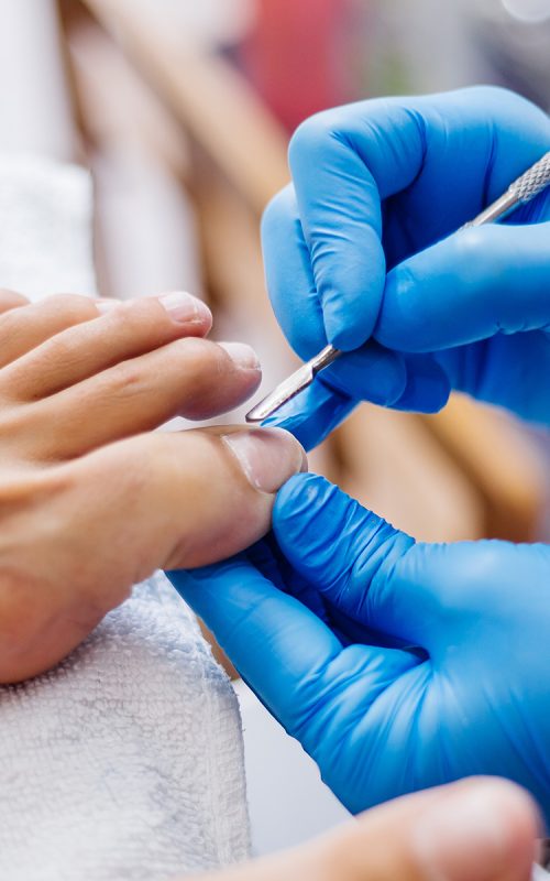 pedicure-process-home-salon-pedicure-foot-care-treatment-nail-process-professional-pedicures-master-blue-gloves-make-pedicure